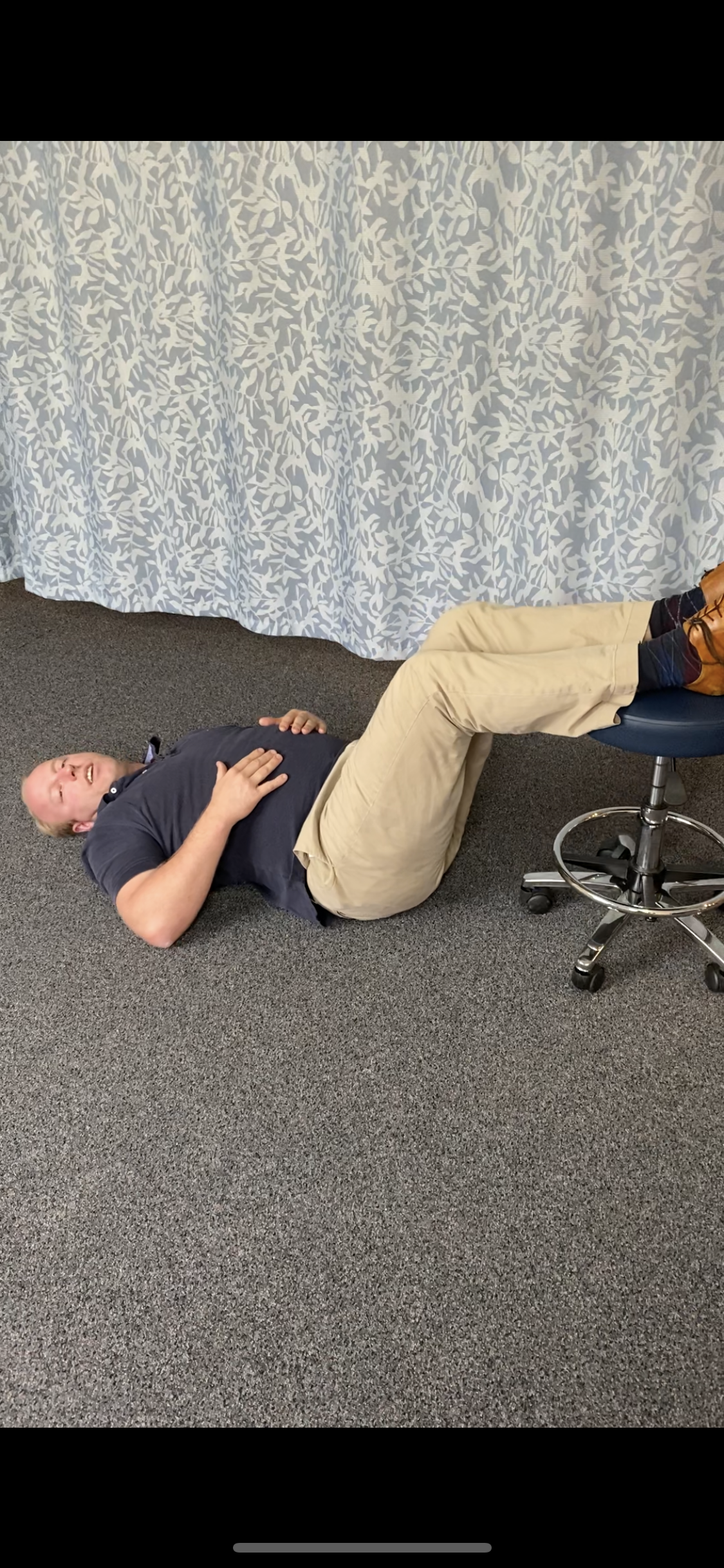 Central Coast Osteopath Dr Daniel Joiner performing static leg raises for acute low back pain management